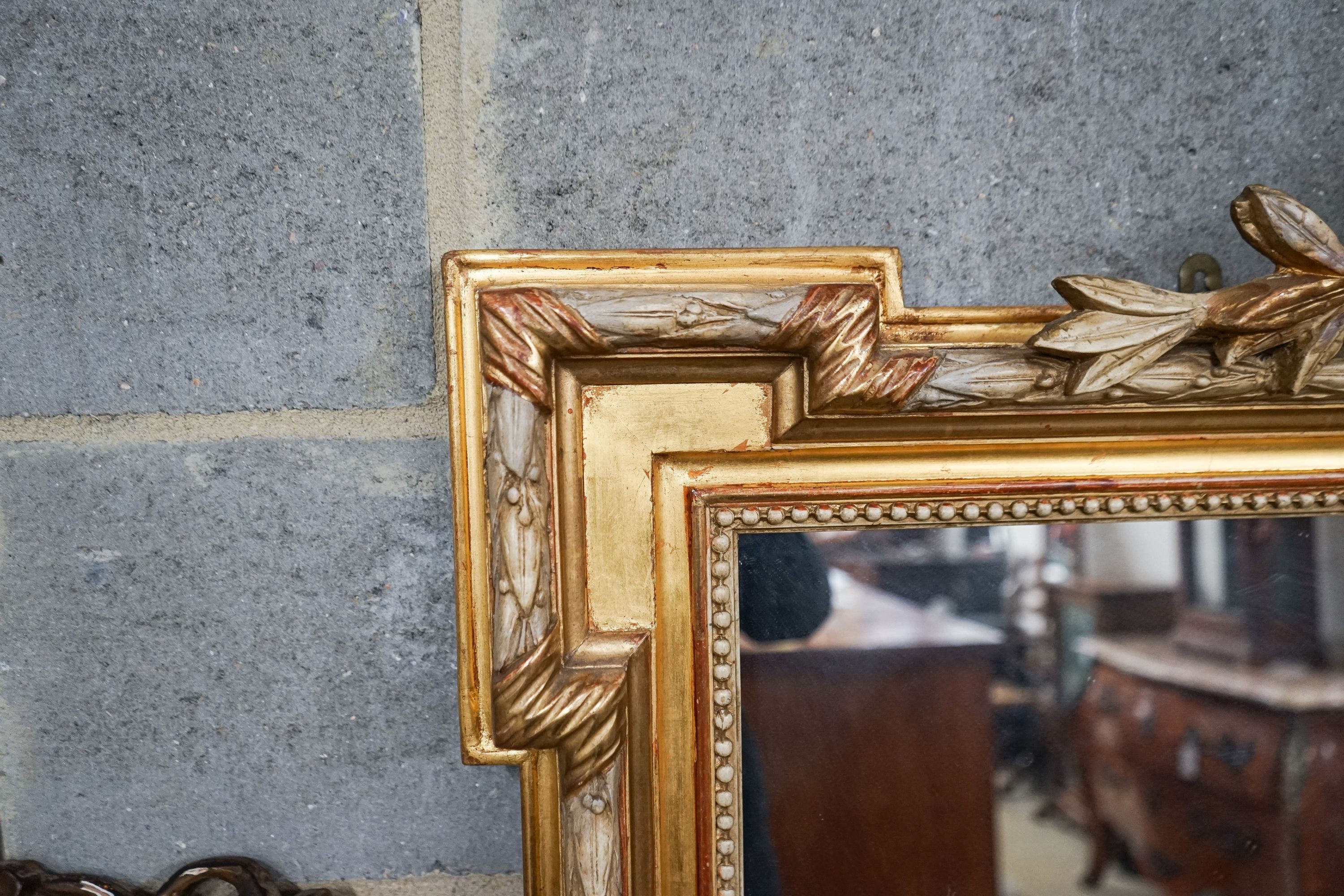 A large Victorian style rectangular carved giltwood overmantel mirror, width 109cm, height 156cm